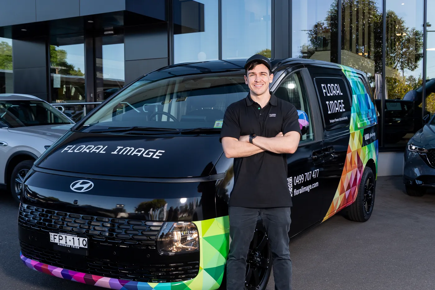 A Floral Image team member with the branded van